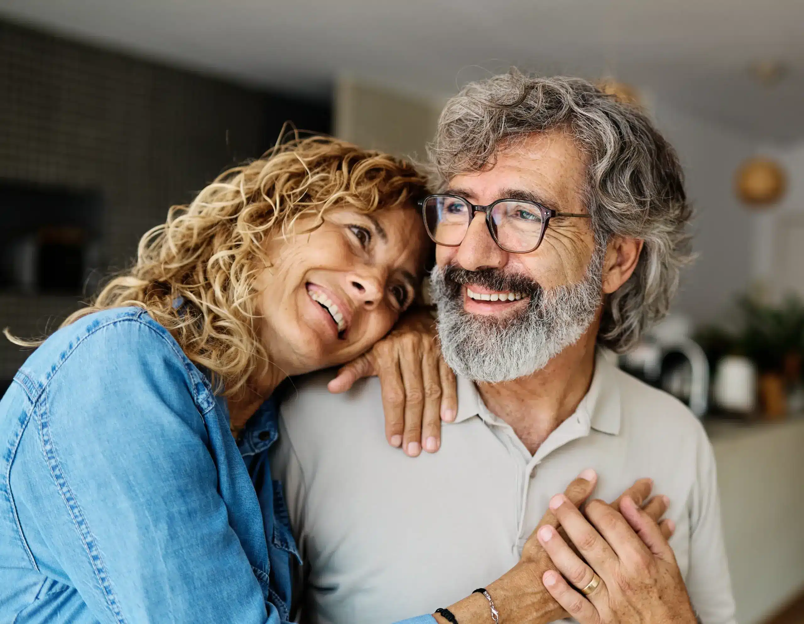 happy couple after getting dentures, natural-looking solutions for missing teeth.